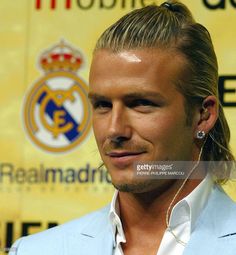 a man with long hair wearing ear buds