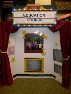 a display with red curtains and yellow stars on the front, which reads education council