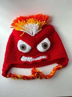 a knitted hat with an angry face on it