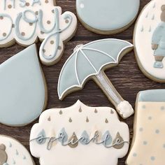 cookies decorated like baby shower items and umbrellas