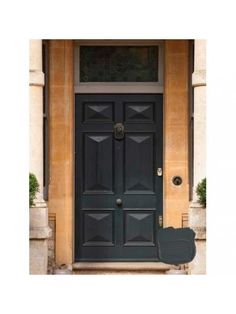 a black door with two planters in front of it