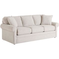 a white couch sitting on top of a hard wood floor next to a pillow case