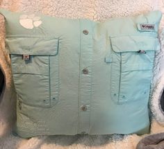 a light blue pillow with white patches on it