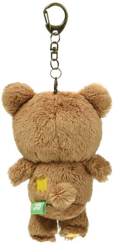 a brown teddy bear keychain with a tag on it's chest and eyes