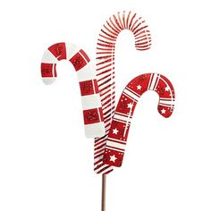 a red and white striped candy cane with stars on it's top, in front of a white background