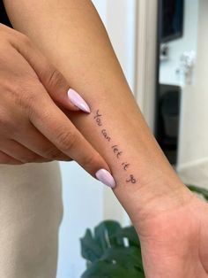 a woman's hand with a small tattoo on her wrist that says, you are loved