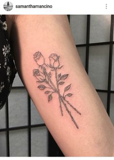 a small rose tattoo on the arm