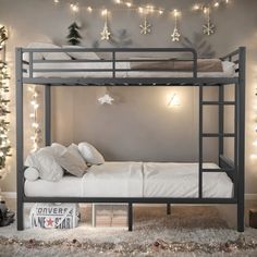 the bunk bed is decorated with christmas lights and garlands on the wall above it