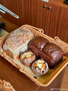 bread and rolls in a wicker basket on a table