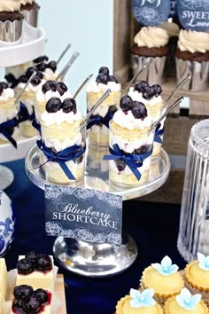 blueberry shortcakes are on display in glass dishes