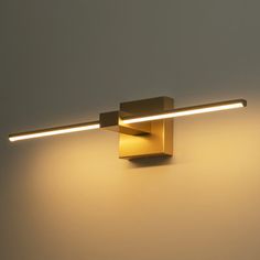 a wall mounted light with two lights on it's side and one light on the other