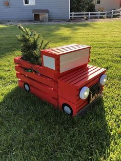 a red truck with a christmas tree in the back