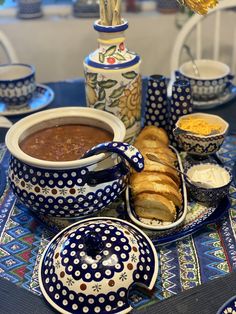 a table topped with plates and bowls filled with food