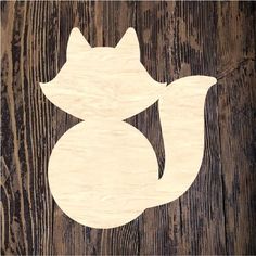 a wood cutout of a cat on a wooden surface