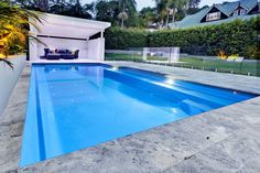 an empty swimming pool in the middle of a backyard