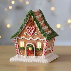 a gingerbread house is decorated with candy canes