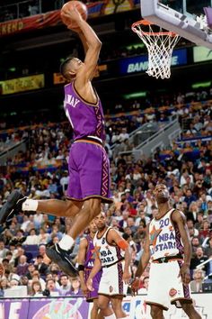 a basketball player jumping up to dunk the ball