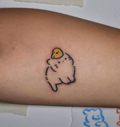 a small tattoo on the arm of a person with a bear in it's hat