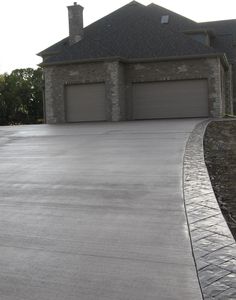 a house with a large driveway in front of it