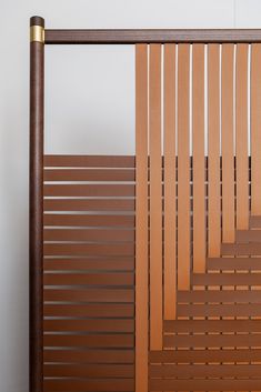 a close up of a wooden slatted door with metal bars on the sides