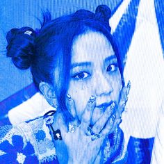 a woman with her hand on her face and blue background in front of the screen