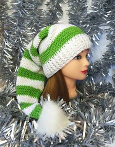 a mannequin head wearing a green and white knitted hat