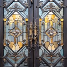 an ornate door with stained glass and metal handles