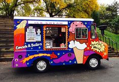 an ice cream truck is parked on the street