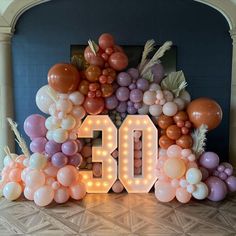 balloons and lights are arranged in the shape of the number 50