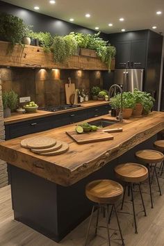 a kitchen with an island and wooden stools in front of the counter top that has potted plants on it