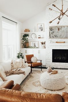 a living room filled with furniture and a fire place in front of a white brick wall