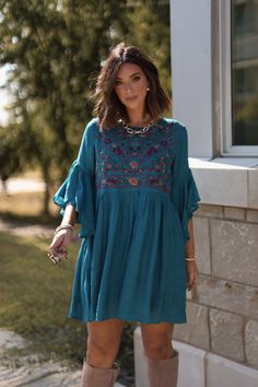 Bring a touch of playful elegance to your wardrobe with the Whimsical Teal Floral Embroidered Mini Dress! With its delicate details and flowy silhouette, this dress is perfect for any occasion that calls for a little fun and flirtation. Designed with airy bell sleeves, this dress offers a romantic and free-spirited feel. Featuring beautiful floral embroidery, this dress brings a whimsical, boho charm to your look. Pair it with your favorite boots for an effortlessly chic look that's ready for any adventure. Elegant Embroidered Bell Sleeve Dress, Elegant Bell Sleeve Embroidered Dresses, Garden Party Midi Dress With Embroidered Hem, Garden Party Midi-length Embroidered Dress, Midi-length Embroidered Dress For Garden Party, Summer Embroidered Mini Dress For Garden Party, Embroidered Mini Dress For Summer Garden Party, Blue Bohemian Dress With Embroidered Neckline, Elegant Summer Embroidered Dress With Embroidered Sleeves