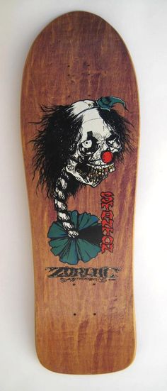 a wooden skateboard with an image of a skeleton on it's back end