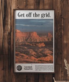 an advertisement for the canyon national park hangs on a wooden wall