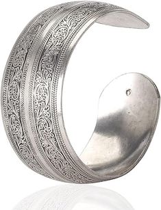 PRICES MAY VARY. Tibetan Silver Material: Crafted from Tibetan silver, this bracelet exudes a unique and elegant charm that is perfect for any woman's wardrobe. Carved Spiral Flower Design: The intricate carvings of spiral flowers and connecting branches create a visually stunning pattern that is both eye-catching and charming. Wide Band Style: The wide band design of this bracelet not only adds a bold and stylish touch to your ensemble, but also ensures a comfortable fit. Open Cuff Style: The o Spiral Flower, Womens Cuff Bracelets, Open Cuff Bracelet, Silver Bangle Bracelets, Elastic Bracelet, Bracelet Bangle, Wide Bands, Adjustable Bracelet, Artisan Jewelry