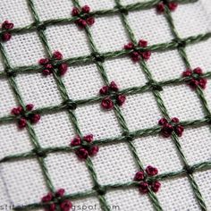 the stitches are stitched together to make a cross - stitch pattern with red flowers