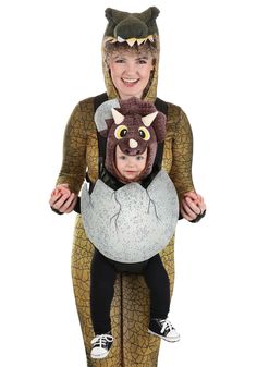 a woman is holding a child in a costume that looks like a cat and mouse