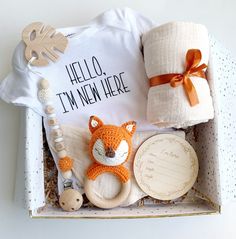 a baby's first birthday gift set in a box with a teddy bear, rattler and blanket