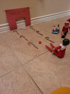 the elf is playing with his toys on the floor