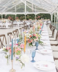 a long table is set with flowers and candles