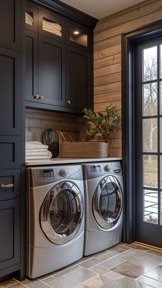 a washer and dryer in a room with wooden walls, flooring and cabinets