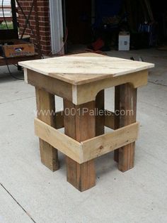 a wooden table sitting on top of a cement floor