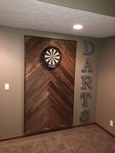 the darts sign is mounted on the wall next to the darts target in the center of the room