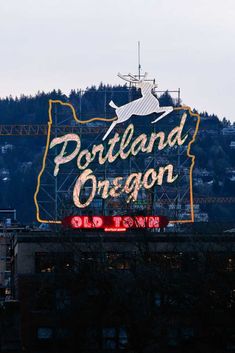 the portland oregon sign is lit up in red and yellow for an outdoor display on top of a building