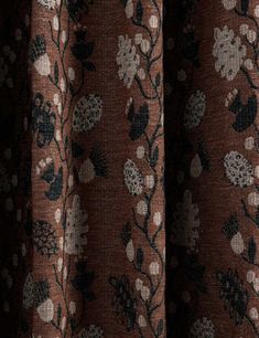 close up view of the fabric with flowers and leaves on it, in brown color