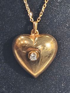 Heart  vintage 14K Gold chain and  heart pendant with  center diamond  Stone diamond 0.10 carats Chain signed 585 14K gold  Chain length 18 inches Total weight 8.7 gramms 14K  Shiny  amazing  One of a kind ! Vintage Diamond Necklace With Diamond Accents, Vintage Diamond Necklace With Accents, Victorian Diamond Necklace With Accents For Anniversary, Victorian Diamond Necklaces For Anniversary, Victorian Necklace For Formal Valentine's Events, Antique Heart-shaped 14k Gold Necklace, Classic Gold Diamond Necklace With Heart Charm, Antique Yellow Gold Necklaces For Valentine's Day, Antique Heart-shaped Necklace For Anniversary