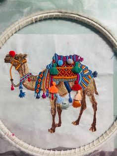 a close up of a piece of art with a camel on it's back