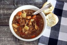 a bowl of stew with bread on the side