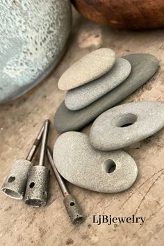 there are some rocks and tools on the table next to each other with holes in them