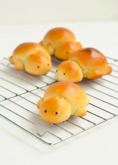 small buns shaped like animals sitting on a cooling rack